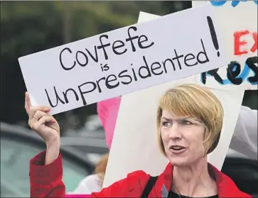  ?? Bill Wechter AFP/Getty Images ?? AT A PROTEST in San Juan Capistrano in June, Annette Lievers holds up a sign mocking President Trump. “Covfefe” — from a fragmented tweet posted by Trump — became shorthand for a social media mistake.