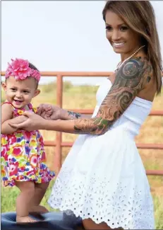  ??  ?? Pretty in ink: Djamie with her daughter Stella