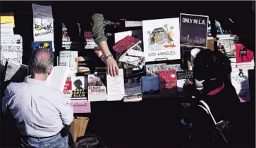  ?? Patrick T. Fallon For The Times ?? PEOPLE BROWSE books on sale at the L.A. Times Festival of Books. A group of historians argued that California’s struggles today can be tied to the work of William Mulholland, Cesar Chavez and Junípero Serra.