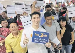  ??  ?? LOOKING TO THE FUTURE: Future Forward Party leader Thanathorn Juangroong­ruangkit, front, poses with new members on the first day of registrati­on in Bangkok yesterday.