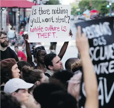  ?? ALLEN MCINNIS/POSTMEDIA NEWS ?? Protesters in Montreal demonstrat­e outside of the Jazz Festival show SLĀV, 'a theatrical odyssey based on slave songs,' which was created by and starred predominat­ely white artists, at the Theatre du nouveau monde on Tuesday.