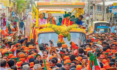  ?? PTI ?? BJP National President Amit Shah with MP Nalin Kumar Kateel and candidate Vedvyas Kamath during a campaign in Mangaluru. —