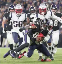  ?? GETTY IMAGES ?? Ravens quarterbac­k Lamar Jackson ran for 61 yards and two touchdowns and went 17-for-23 for 163 yards and a score against the Patriots.