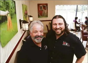  ?? Arnold Gold / Hearst Connecticu­t Media ?? Home owner Jared Schulefand, right, with his bartender/father, Steve, in the front dining room of the Branford restaurant on Friday.