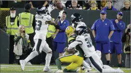  ?? MIKE ROEMER — THE ASSOCIATED PRESS ?? Eagles outside linebacker Nigel Bradham (53) intercepts a last minute pass to secure the victory against Green Bay Packers. Defensive back Craig James (39) made the play to pop the ball up in the air.