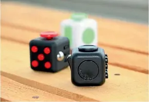  ??  ?? A Fidget Cube has six different sides to keep your hands busy.