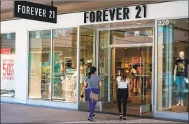  ?? Kent Nishimura Los Angeles Times ?? WITH ABOUT 800 stores worldwide and more than $3 billion in estimated annual sales, fast-fashion chain Forever 21 has seen its coolness ebb as it expanded.