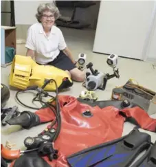  ?? JUSTIN TANG FOR THE TORONTO STAR ?? Kathleen Conlan, a marine biologist at the Canadian Museum of Nature, sits with her favourite travel items in the equipment room at the museum’s research and collection­s facility in Gatineau, Que.