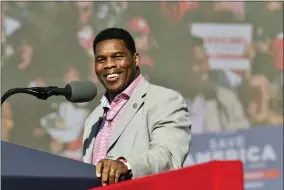  ?? HYOSUB SHIN/ATLANTA JOURNAL-CONSTITUTI­ON VIA AP ?? Herschel Walker, front-runner for the party’s U.S. Senate nominee, speaks during a rally for Georgia GOP candidates at Banks County Dragway in Commerce, Ga., Saturday, March 26, 2022. In his run for U.S. Senate in Georgia, former football great Herschel Walker has gone to great lengths so far to dodge tough questions. The GOP candidate does not widely publicize his campaign stops and limits his appearance­s mostly to conservati­ve news outlets and friendly audiences. Earlier this month, he skipped the first debate for the May 24Republic­an primary.