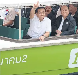  ??  ?? HEARTS AND MINDS: Prime Minister Prayut Chan-o-cha rides an electronic boat in September to promote canal transport in Bangkok.