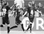  ?? MIKE EHRMANN/GETTY IMAGES ?? FC Barcelona’s Ivan Rakitic, right, celebrates his goal with Neymar, center, and Aleix Vidal against Real Madrid.