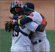  ?? (AP/Ashley Landis) ?? Houston Astros catcher Martin Maldonado (left) hugs Carlos Correa after the Astros defeated the Oakland Athletics in Game 4 of the American League division series. The Astros meet the Tampa Bay Rays in the American League Championsh­ip Series, which starts today in San Diego.