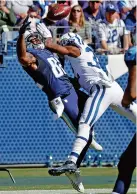  ?? THE ASSOCIATED PRESS ?? Tennessee Titans tight end Delanie Walker, left, reaches for a pass while covered by the Indianapol­is Colts’ T.J. Green during the first half Sunday in Nashville. Green was called for pass interferen­ce on the play.