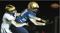  ??  ?? Clarkston’s Michael Hein (left) breaks up the pass intended for Stoney Creek’s Sam McDermott during the OAA Red game played on Friday at Stoney Creek High School.