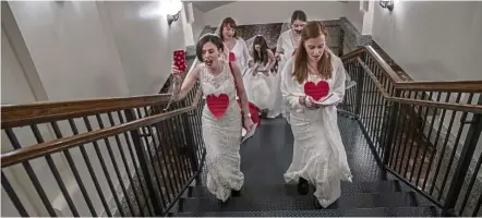  ?? — Photos: Tns ?? supporters in wedding dresses and chains making their way to the state Capitol rotunda to advocate a ban on child marriage.