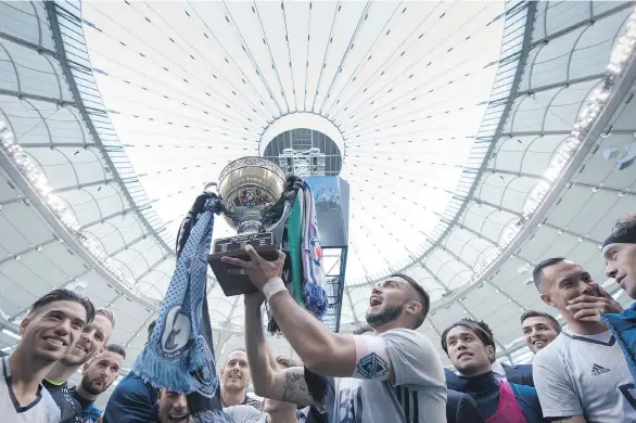  ?? THE CANADIAN PRESS ?? Whitecaps captain Pedro Morales hoists the Cascadia Cup after Vancouver defeated Portland on Sunday. Meanwhile, the loss kept the Timbers out of the playoffs.