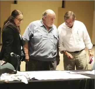  ?? Katie West • Times-Herald ?? Dr. Cathie Cline, President of East Arkansas Community College, shares preliminar­y blue prints of renovation­s to the old CRTI building with Dr. Don Lewis, EACC Math/Science Instructor, and Brent Howton, EACC Board Chair. Cline reported updates to the board Thursday night.