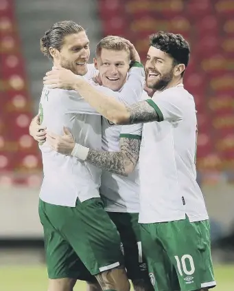  ??  ?? Republic of Ireland’s James McClean (centre) celebrates scoring against Qatar.