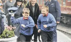  ??  ?? Harley North and Leon Palmer of Brompton Hall School having a laugh along the platform. 164317h