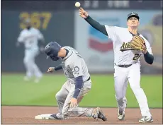  ?? D. ROSS CAMERON —AP ?? The Athletics’ Matt Chapman throws to first base too late after forcing out Seattle’s Mitch Haniger on a grounder by Kyle Seager in the fourth inning.