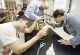  ?? AP FILE PHOTO ?? High school students work with a teacher in an agricultur­e-careers class.