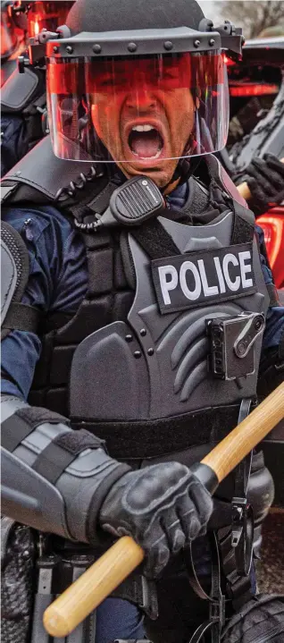  ??  ?? Tension: An officer in riot gear during last night’s protests