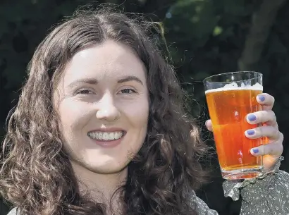  ?? PHOTO: GREGOR RICHARDSON ?? Dunedin food science hops researcher Victoria Purdy with a craft beer.