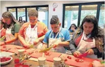  ?? COURTESY OF FLORIDA HOSPITAL ?? Students learn how to prepare and cook healthy food at Emeril's Kitchen House &amp; Culinary Garden, near Florida Hospital of Children.