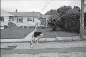  ?? SEAN D. ELLIOT/THE DAY ?? Norwich Public Works Director Ryan Thompson jogs Friday along Everett Avenue as he takes to the streets of Norwichtow­n to look for issues to be addressed by his department.