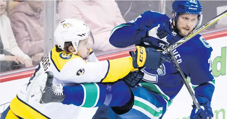  ?? — THE CANADIAN PRESS ?? Nashville’s Filip Forsberg, left, shoves the Canucks’ Alexander Edler, a fellow Swede, during Friday’s night’s game in Vancouver.