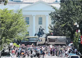  ?? WIN MCNAMEE GETTY IMAGES ?? National Guard vehicles block 16th Street near the White House in Washington, D.C., on Wednesday while people protest against police brutality and the death of George Floyd.