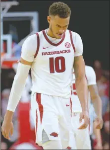  ?? NWA Democrat-Gazette/Andy Shupe ?? LOTTERY NUMBERS: Arkansas sophomore center Daniel Gafford walks to the team’s bench in the closing moments of regulation Saturday during the second half of the Razorbacks’ 94-88 overtime defeat to LSU in Bud Walton Arena in Fayettevil­le. Gafford scored a career-high 32 points after being held to nine points in a 57-51 loss to Florida on Wednesday. Fellow NBA prospect Naz Reid scored 27 points for the Tigers.