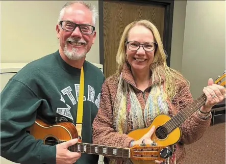 ?? — JEFF Vorva/chicago Tribune/tns ?? Lilly (left) and snow met after joining a Naperville ukulele group, which gathers to play once a weekly and performs publicly.