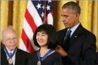  ?? CARLOS BARRIA / REUTERS ?? US President Barack Obama awards landscape architect Maya Lin the Presidenti­al Medal of Freedom during a ceremony in the East Room of the White House in Washington on Tuesday.