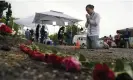  ?? Photograph: Eric Gay/AP ?? A person prays after placing roses on a makeshift memorial where the bodies were found.