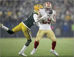  ?? NHAT V. MEYER — BAY AREA NEWS GROUP FILE ?? The San Francisco 49ers’ Elijah Mitchell (25) makes a catch against the Green Bay Packers’ Eric Stokes (21) in the third quarter of their NFC divisional playoff game at Lambeau Field in Green Bay, Wis., on Saturday, Jan. 22.