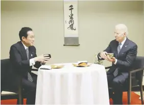  ?? JAPAN'S CABINET PUBLIC RELATIONS OFFICE VIA KYODO/VIA REUTERS ?? U.S. President Joe Biden, right, experience­s a traditiona­l tea ceremony with Japan's PM Fumio Kishida during a private dinner in Tokyo Monday.