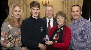  ??  ?? Conor Keane, joint winner of the Tony Boland Award for best results, receives his award from Margaret Boland. Also pictured are Kathleen and Barry Keane, and school principal Michael McMahon.