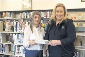  ??  ?? GIFT WITH MEMORIES: U3A Stawell president Garbrielle Chamberlin, left, presents books to Stawell librarian Kerry Wilson.