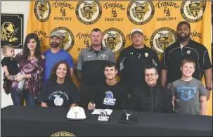  ?? The Sentinel-Record/Grace Brown ?? TROJAN SIGNING: Hot Springs’ Ben Slate, center, signed a letter of intent on Wednesday to play baseball for Central Baptist College in Conway. He was accompanie­d at Hot Springs World Class High School, in front, from left by his mother, Robin Slate; father, David Slate; and Mark Lusher; and back, from left, Gabriel Dankert, Ashley Dankert, Daniel Dankert, coach Brandon Bates, coach Kurk Wasson and Hot Springs Athletic Director Rodney Echols.