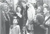  ?? AP ?? Karolyn Grimes is held by Jimmy Stewart, center, while Jimmy Hawkins has his hands on his face in “It’s a Wonderful Life.”