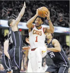  ?? Tony Dejak ?? The Associated Press Cavaliers guard Derrick Rose drives between Magic guard D.J. Augustin, left, and UNLV product Khem Birch in the first half of Cleveland’s 104-103 win Thursday at Quicken Loans Arena.