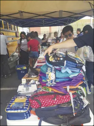  ?? CONTRIBUTE­D ?? Stacks of donated backpacks sit on a table during Comunities in Schools of Southern Nevada’s Fill the Bus donation drive in 2017. This year’s drive, which benefits more than 50,000 students in the Clark County School District, takes place Friday at two...