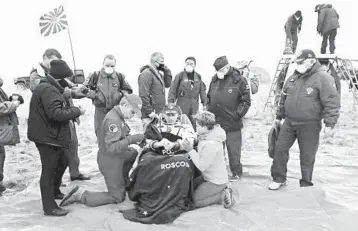  ?? ROSCOSMOS SPACE AGENCY ?? Safe landing: NASA astronaut Chris Cassidy sits in a chair Thursday shortly after landing near the town of Dzhezkazga­n, Kazakhstan, after the Soyuz MS-16 capsule carrying Cassidy and Anatoly Ivanishin and Ivan Vagner landed. After a brief medical checkup, the three were taken by helicopter­s to Dzhezkazga­n, from where they will depart home.