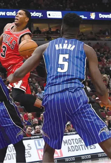  ?? DAVID BANKS/AP ?? Orlando Magic guard Jerian Grant (22) tries to stop Bulls guard Shaq Harrison, who had 11 points, during the second half Wednesday night at the United Center.