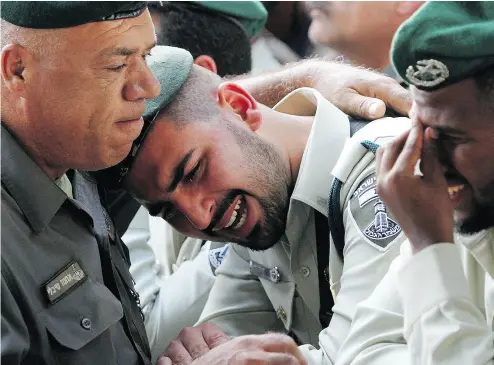  ?? COHEN- MAGEN / AFP / GETTY IMAGES ?? Israeli security forces mourn Tuesday at the funeral of Israeli border police officer Solomon Gabariya, one of three Israeli guards killed in a Palestinia­n shooting attack on a Jewish settlement in the West Bank.