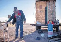  ??  ?? David Miller and his dog, Snow, pictured next to the man’s broken-down trailer on the outskirts of Columbus, N.M., on Wednesday. Miller is in the area assisting members of a militia hoping to help in apprehendi­ng illegal immigrants.