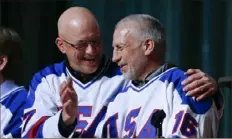  ?? Mike Groll/Associated Press ?? Mark Pavelich, right, and Jack O'Callahan of the 1980 U.S. hockey team talk during a reunion at Herb Brooks Arena in Lake Placid, N.Y. Mr. Pavelich died Thursday at age 63.