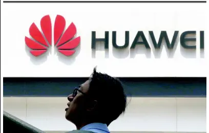  ?? AP ?? In this photo taken on Thursday, May 16, a man passes by a Huawei store in Beijing. Google is assuring users of Huawei smartphone­s the American company’s services will still work on them following the US government restrictio­ns on doing business with the Chinese tech giant.