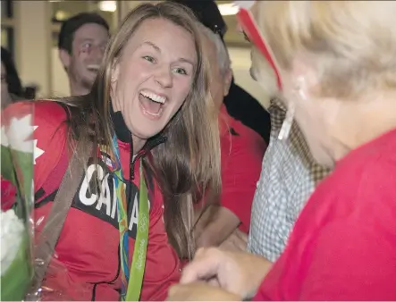  ?? CRYSTAL SCHICK ?? Rio Olympic gold medal wrestler Erica Wiebe returns to Calgary and is greeted by family, friends and fans on Friday.